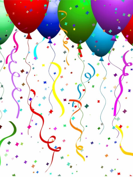 Colorful balloons and streamers decorate a birthday party scene with confetti around