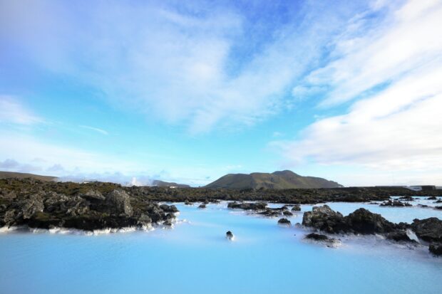 A scenic view of geothermal water surrounded by rocks at Blue Lagoon Iceland