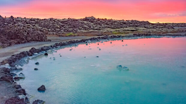 Blue Lagoon Iceland natural geothermal pool under a colorful sunset sky