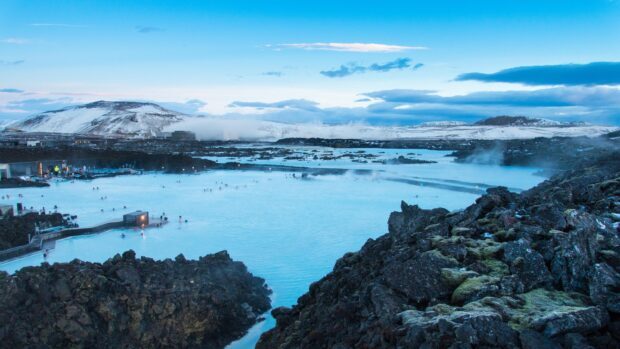 Blue Lagoon Iceland geothermal spa surrounded by volcanic rocks and snowy mountains