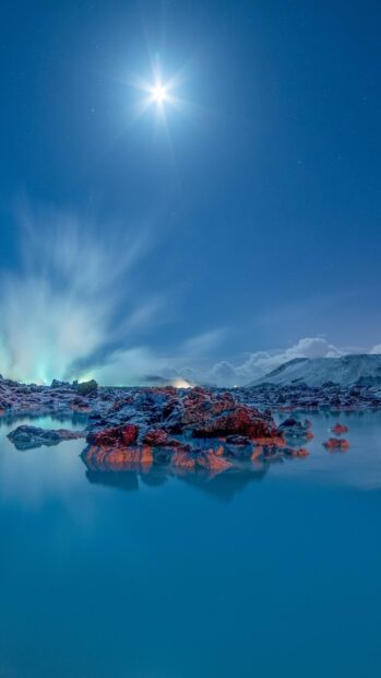 Blue Lagoon Iceland with steaming rocks under a bright moon in a clear night sky