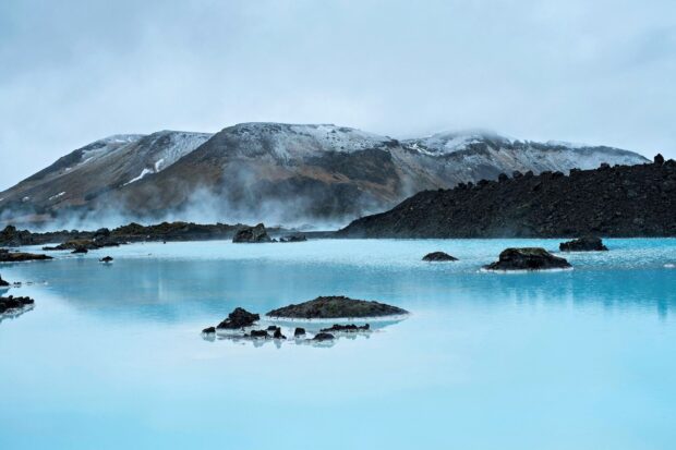 Volcanic landscape with blue lagoon steam in Icelandic nature