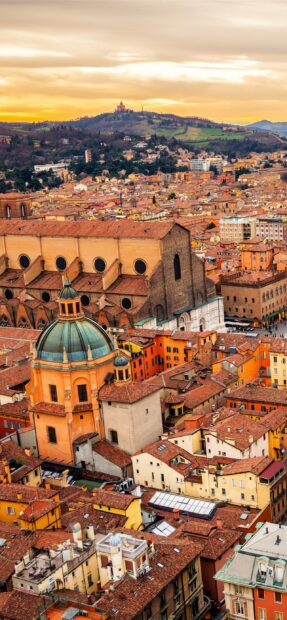 A panoramic view of Bologna cityscape with historic architecture and hills in the background