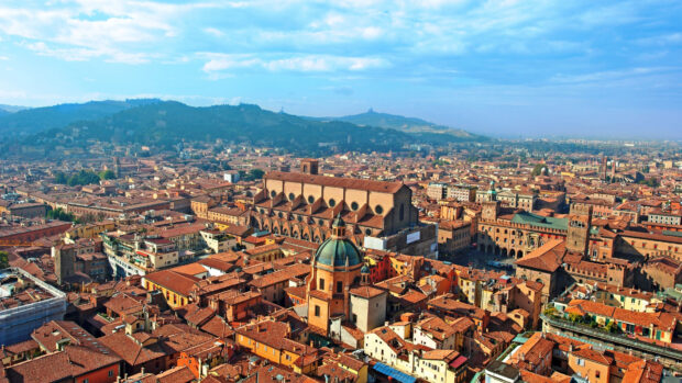 A panoramic view of Bologna cityscape with historic architecture and hills in the background