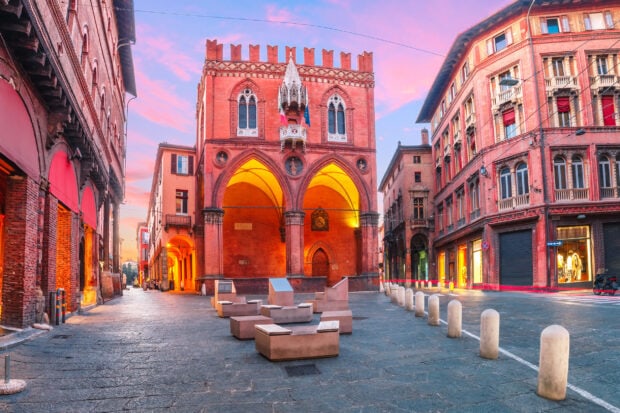 Historic building in Bologna city center during sunset with colorful sky
