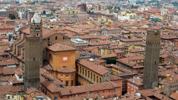 Historic towers and old buildings in Bologna cityscape with terracotta roofs