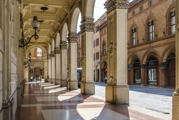 The beautiful arches and columns detail of Bologna city street scene in daylight