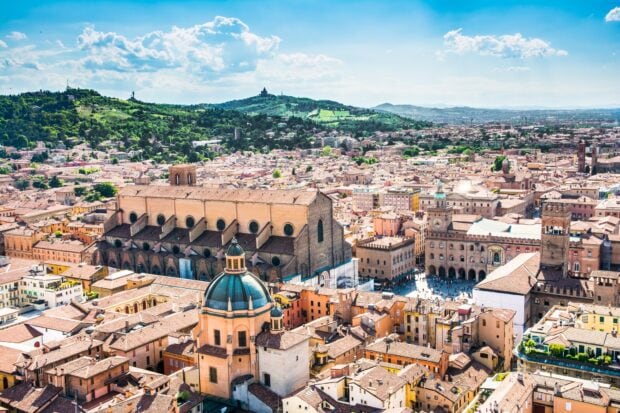 Historic architecture and cityscape of Bologna with hills in the background