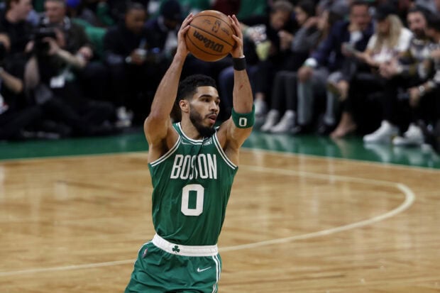 Boston Celtics player preparing to shoot a basketball during a game on the court