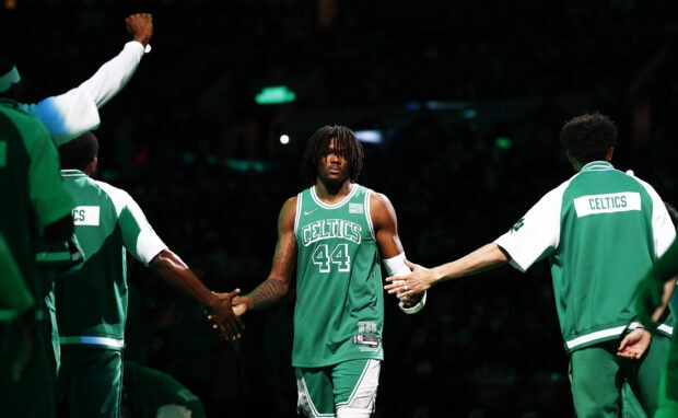 Boston Celtics player wearing number 44 jersey greeting teammates before the game in the arena