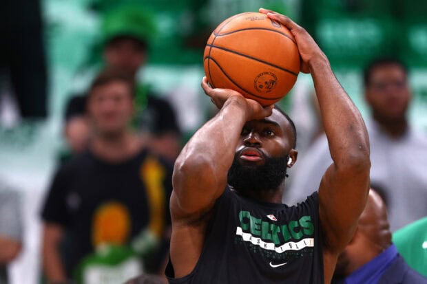 A Boston Celtics player preparing to shoot a basketball during practice session