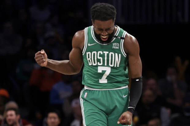 A Boston Celtics player celebrating a victory during an intense basketball game