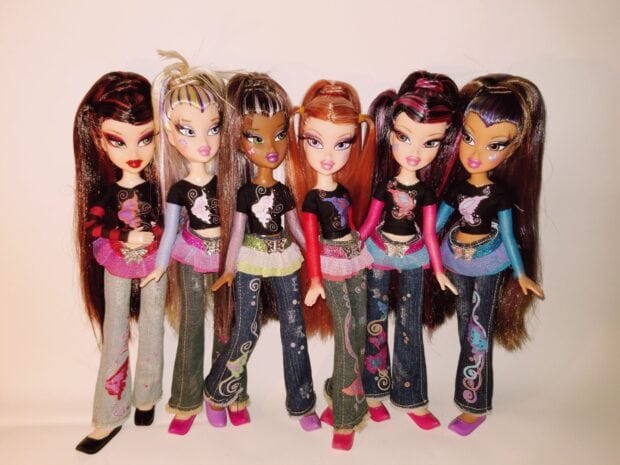 A group of Bratz Dolls wearing colorful outfits and detailed jeans standing together