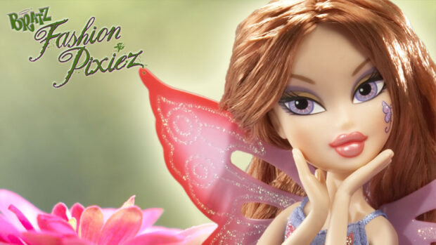 Close up of Bratz doll with purple eyes and red hair posing with hands near face