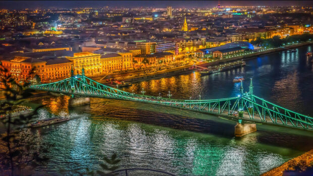 Nighttime cityscape of Budapest with Liberty Bridge spanning the illuminated river