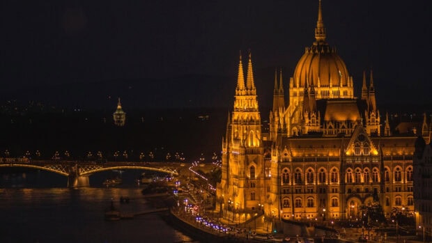 The Budapest Parliament building illuminated at night in Budapest cityscape