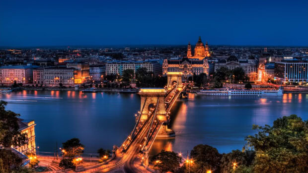 Night view of Budapest cityscape with chain bridge and river in the background