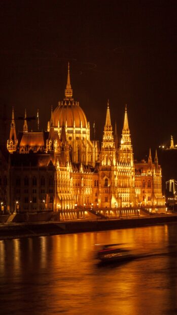 Night view of Budapest architecture reflecting on the river with bright lights