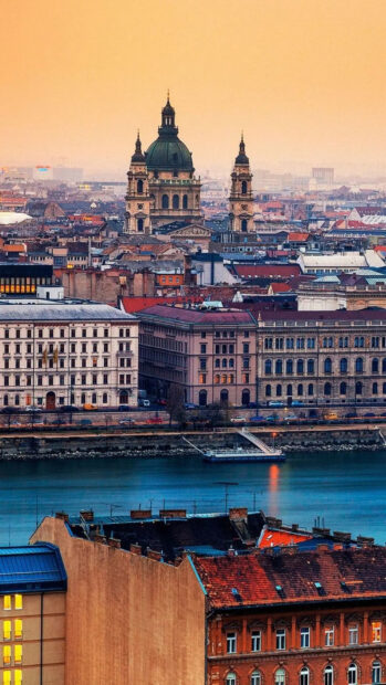 A detailed view of Budapest architecture featuring historical buildings and the river at sunset
