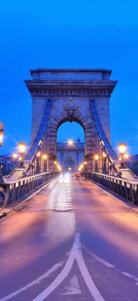 Chain bridge architecture is illuminated in Budapest at dusk