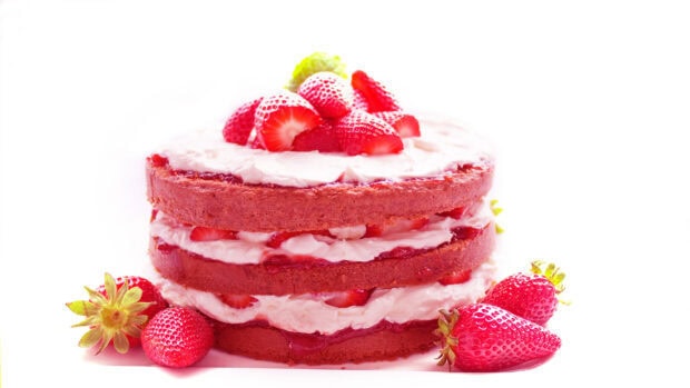 Delicious strawberry cake with cream layers and fresh strawberries on top
