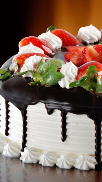 Fresh strawberries and cream topping on a chocolate covered cake