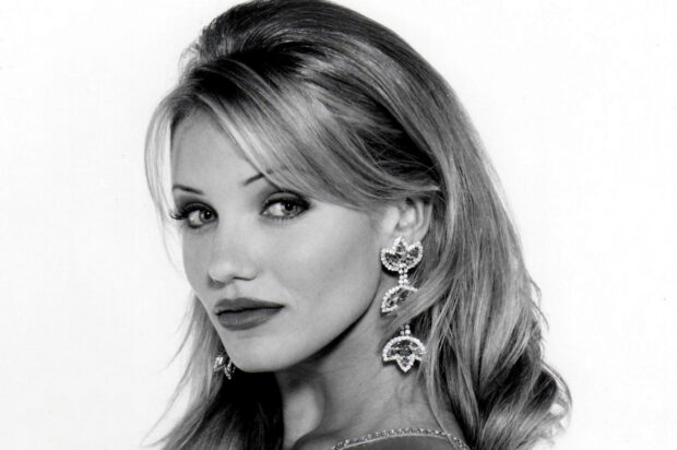 Cameron Diaz with elegant earrings looking over her shoulder in a black and white portrait