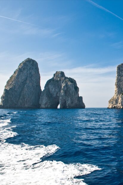 Capri Island rock formations rising from the sea under a clear blue sky