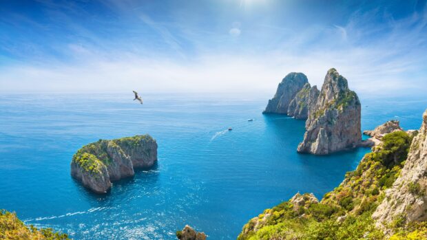 Stunning Capri Island view with rocky cliffs and clear blue sea under bright sky