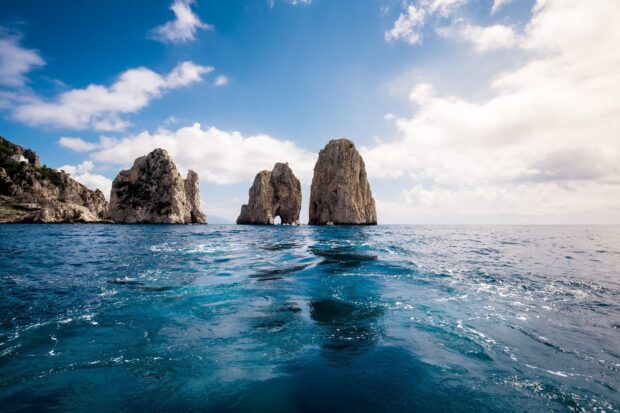 Clear view of Capri Island rock formations with deep blue sea and bright sky