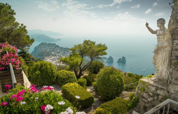 Ancient statue overlooking Capri Island and lush garden view in HD