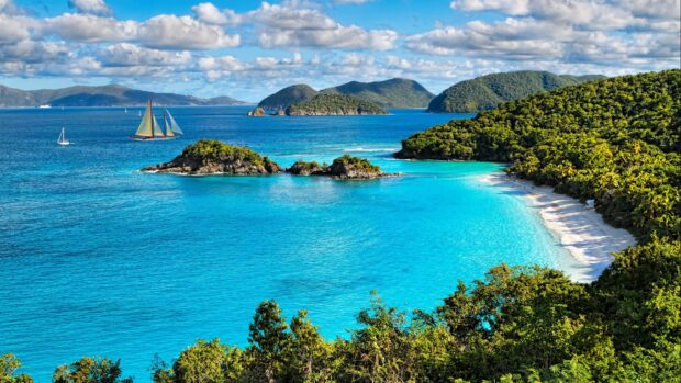 A peaceful Caribbean Islands scene with clear blue water and lush green hills in high resolution