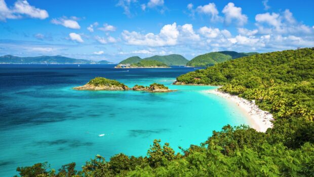 Tropical Caribbean Islands with lush greenery and turquoise waters under a bright blue sky
