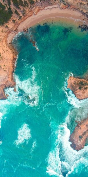Aerial view of turquoise waters and rocky shoreline in Caribbean Islands