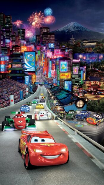 Animated racing cars from a Cars Disney movie compete on a vibrant city race track at night