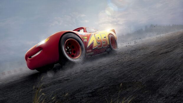 Red car with number 95 racing on dirt road in Cars Disney