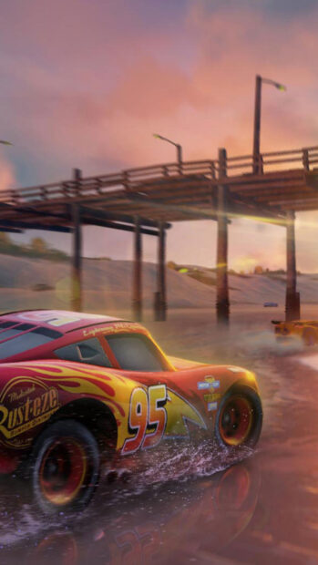 Lightning McQueen racing on a wet beach near a wooden pier in Cars Disney scene