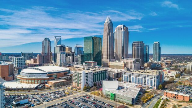 A clear view of Charlotte skyline buildings with blue sky and urban architecture