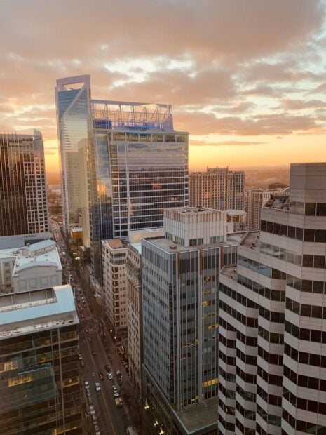 Modern Charlotte skyline at sunset showcasing urban architecture and city streets