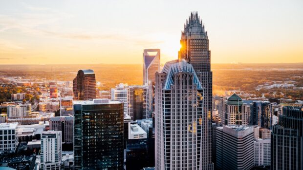 Tall buildings in Charlotte skyline during sunset with clear sky and cityscape view