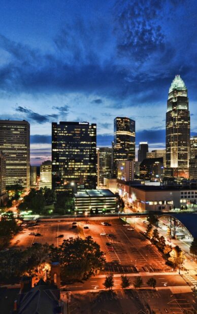 Night view of Charlotte skyline with illuminated buildings and vibrant city lights
