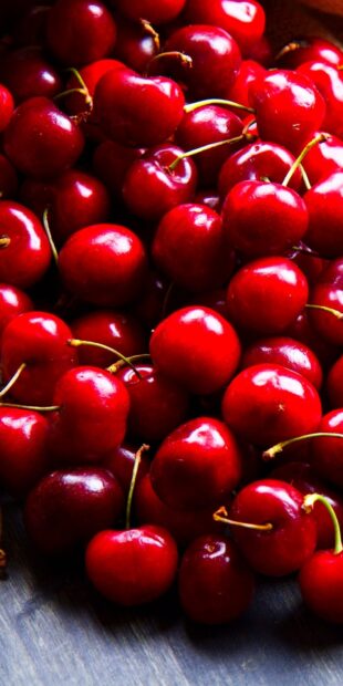 Fresh ripe cherry fruits closeup on wooden surface