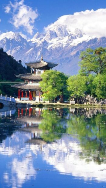 Traditional Chinese temple surrounded by green trees and mountains in China