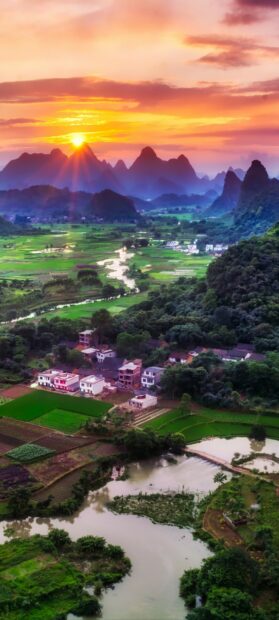 Sunrise over mountains and river in China countryside landscape