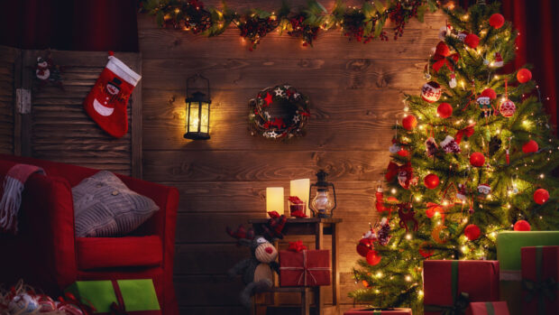 Cozy Christmas tree decorated with lights and ornaments in a warm wooden room