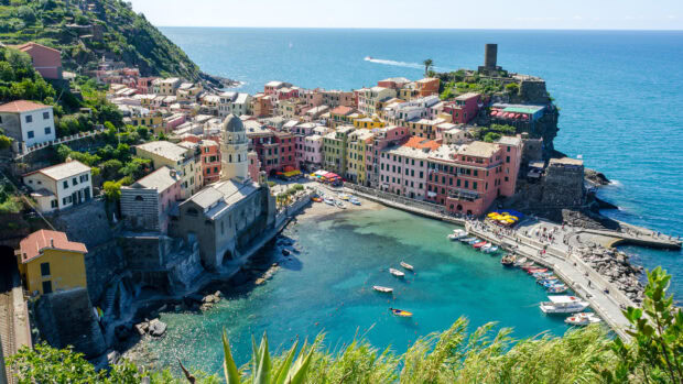 A panoramic view of Cinque Terre coastal town with colorful buildings and clear blue sea in Italy