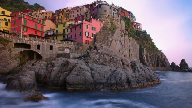Colorful houses on rocky cliffs of Cinque Terre at sunset