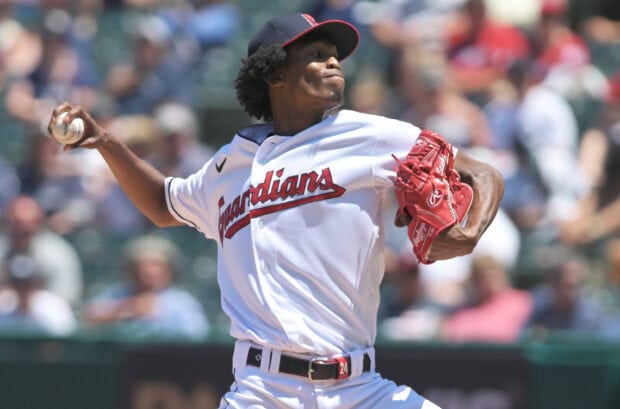 A Cleveland Guardians pitcher throwing a baseball during a game in high resolution