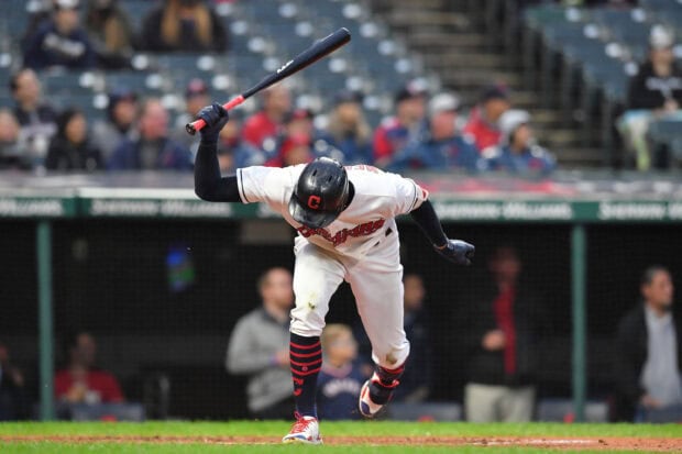 Cleveland Guardians player swinging a bat during a baseball game at the stadium