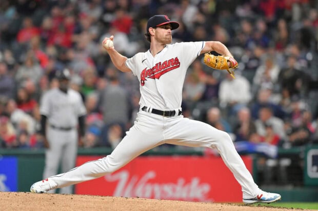 Cleveland player pitching a baseball on the mound during a game in Cleveland Guardians uniform